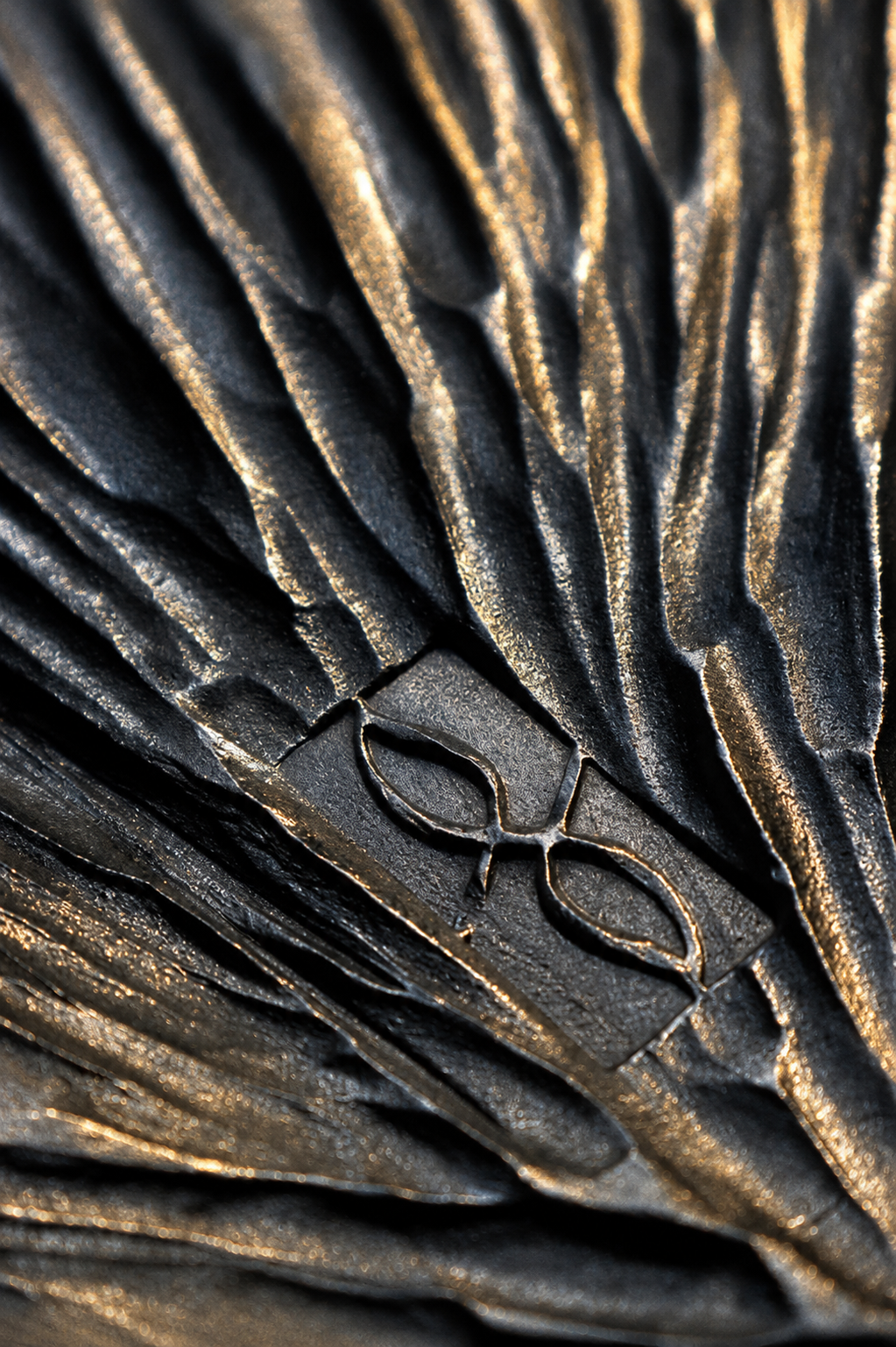 Blackened steel and warm metal texture