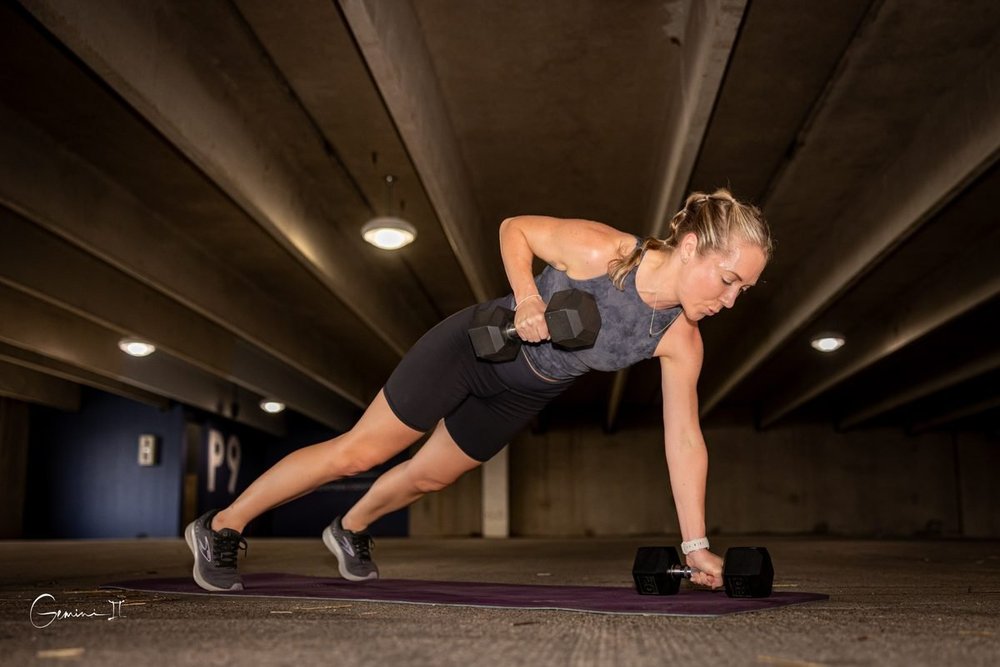 Coach Lisa doing a dumbbell row during a strength workout