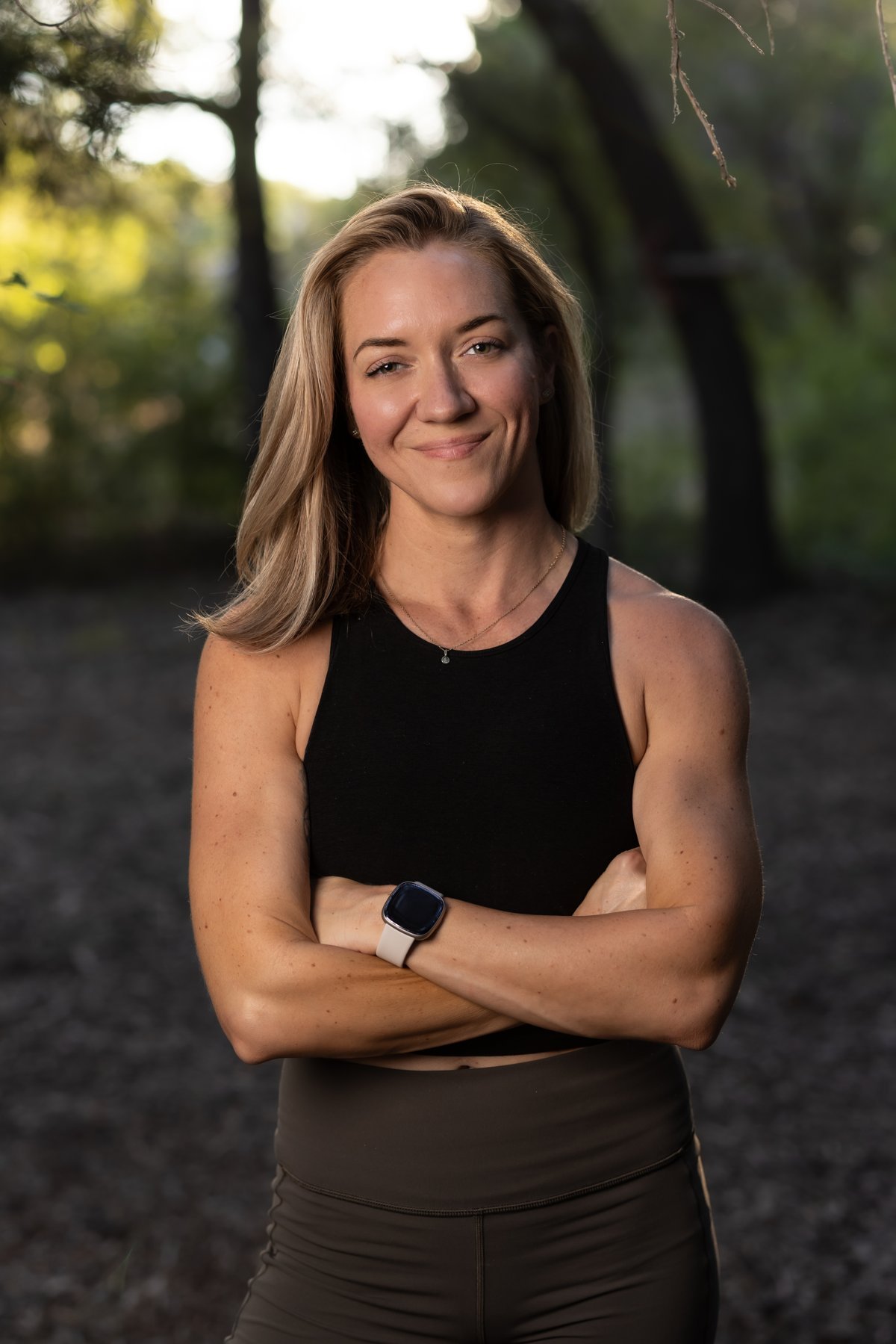 Coach Lisa Wade, NASM-certified personal trainer for women over 40, smiling with arms crossed outdoors