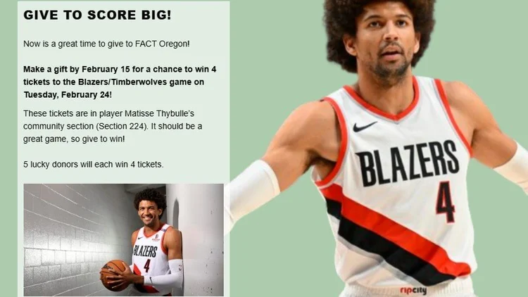 A basketball player stands with his arms wide.