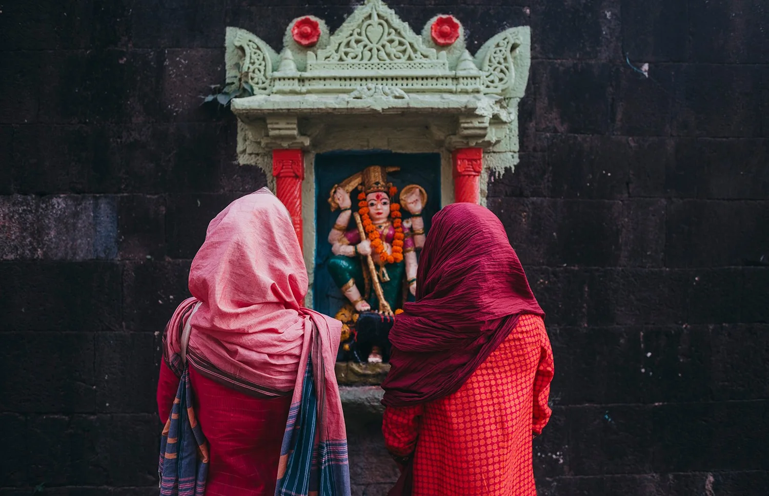 Women in saris offering at a shrine in India, from a past Body Temple journey