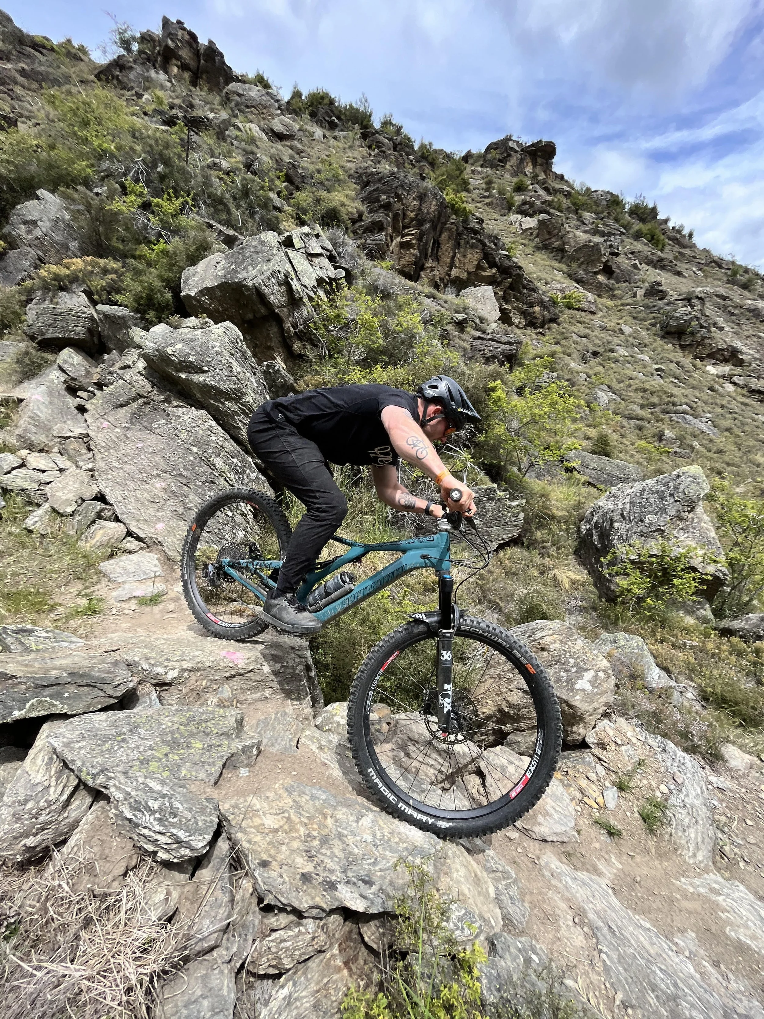 Mountain biker responding to a technical trail feature