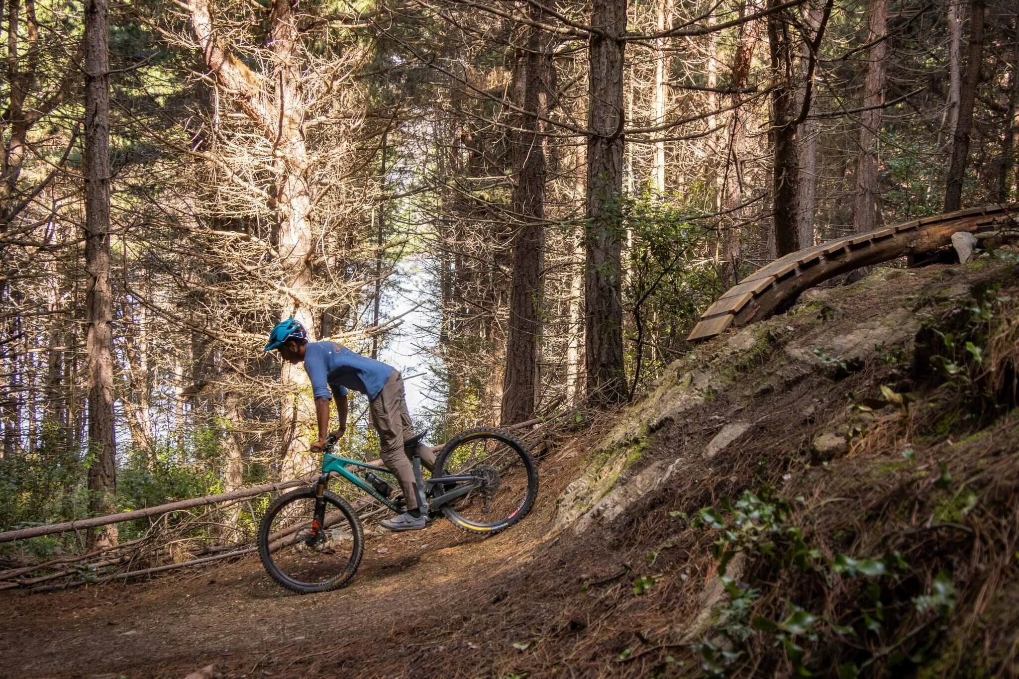 Rider returning to a tall and strong position as a steep mountain bike feature flattens
