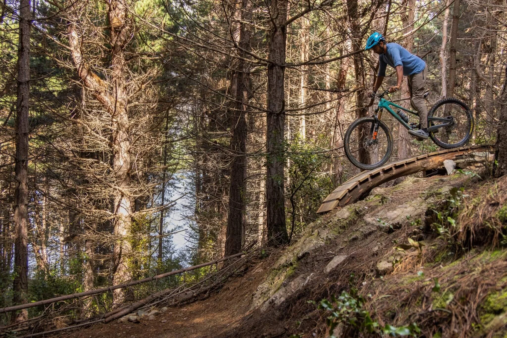 Rider approaching a steep mountain bike feature in a tall and strong position