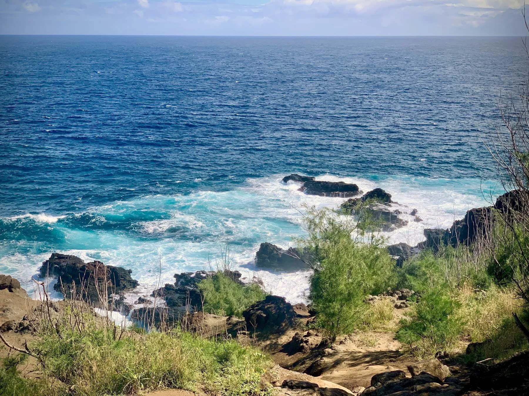 Waves breaking over volcanic rock along the Hawaiʻi coastline