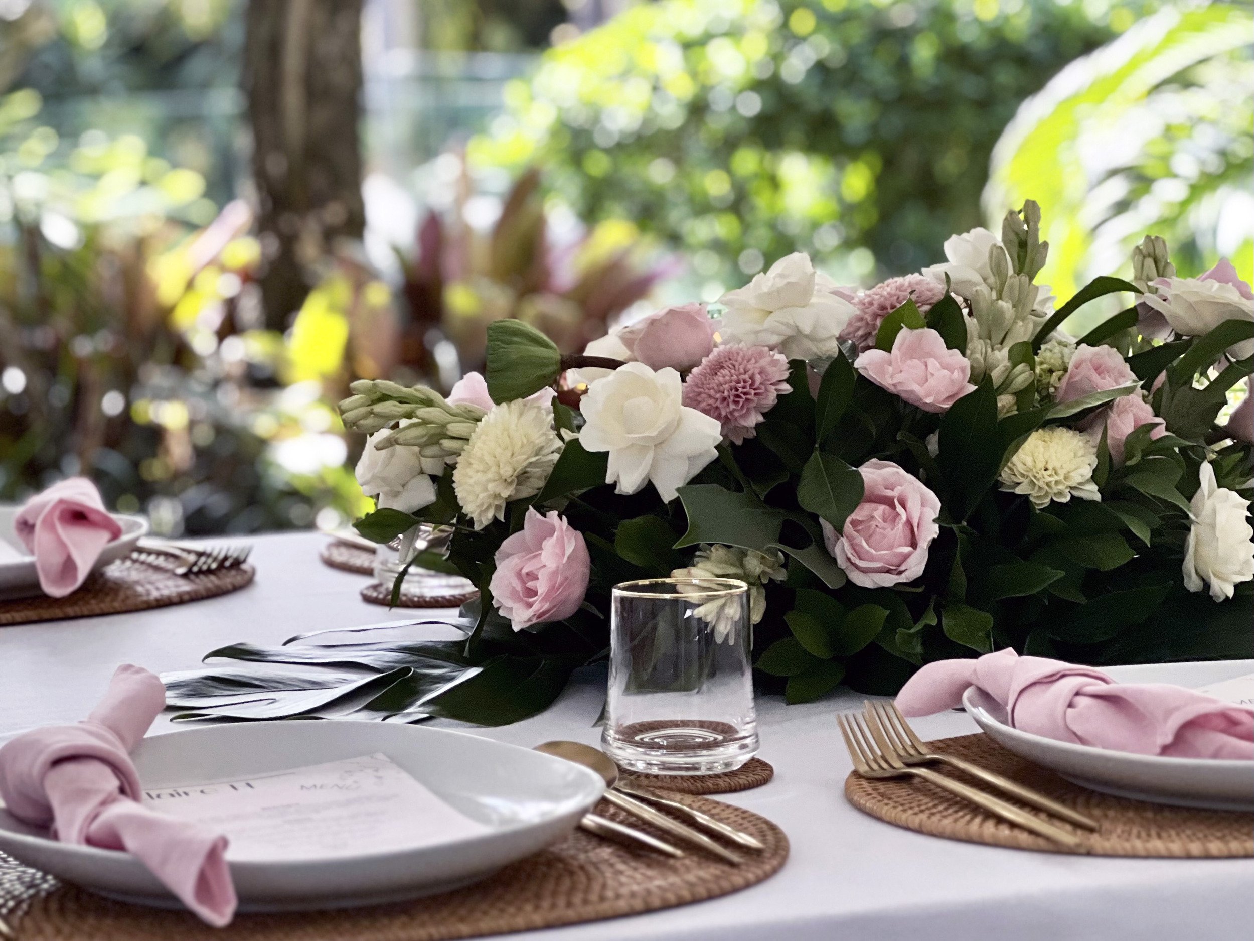 Flowers and place settings on a wedding table