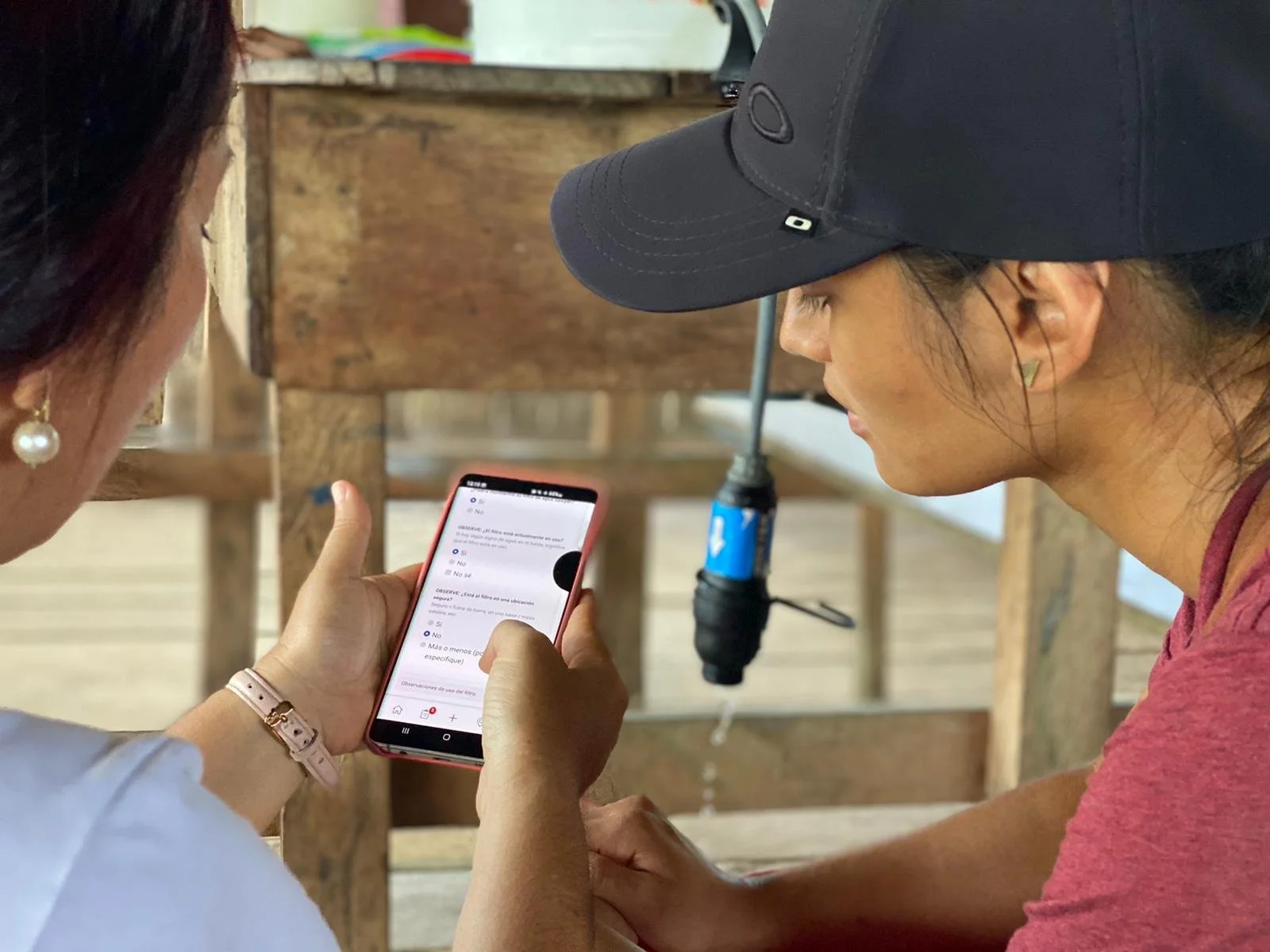Field researcher recording water quality data on a mobile device