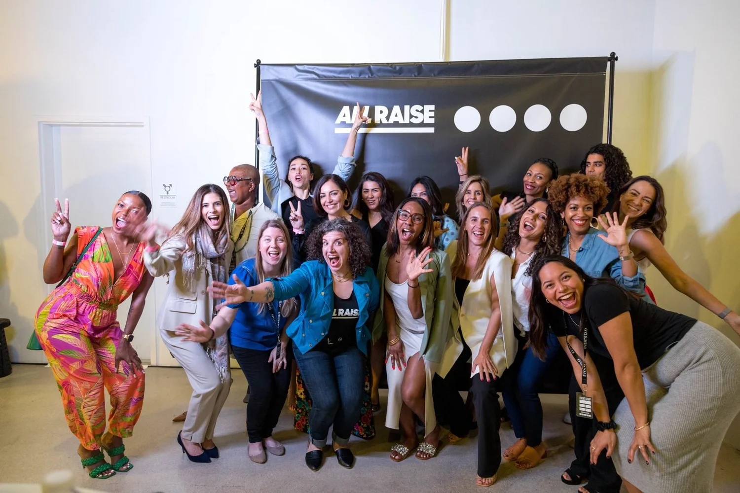 A crowd celebrating at the All Raise Miami launch event