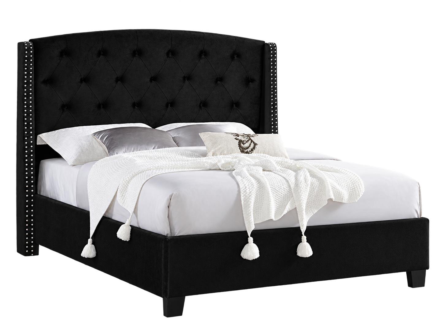 Black upholstered bed with tufted headboard and nailhead trim