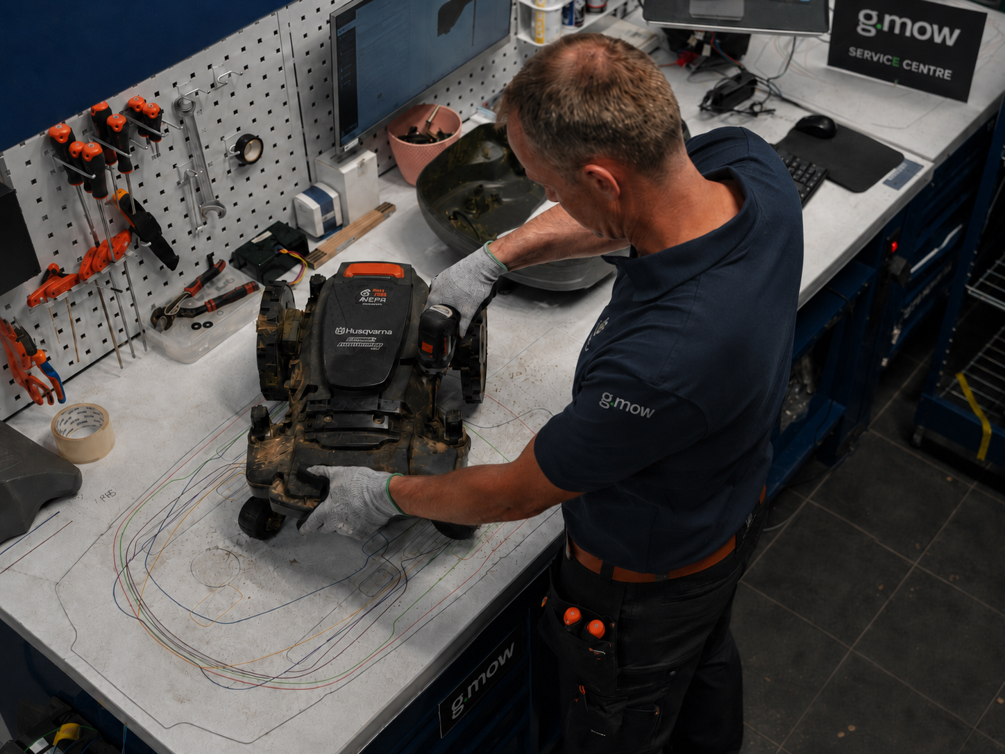 Husqvarna Automower undergoing detailed workshop repair at G.MOW