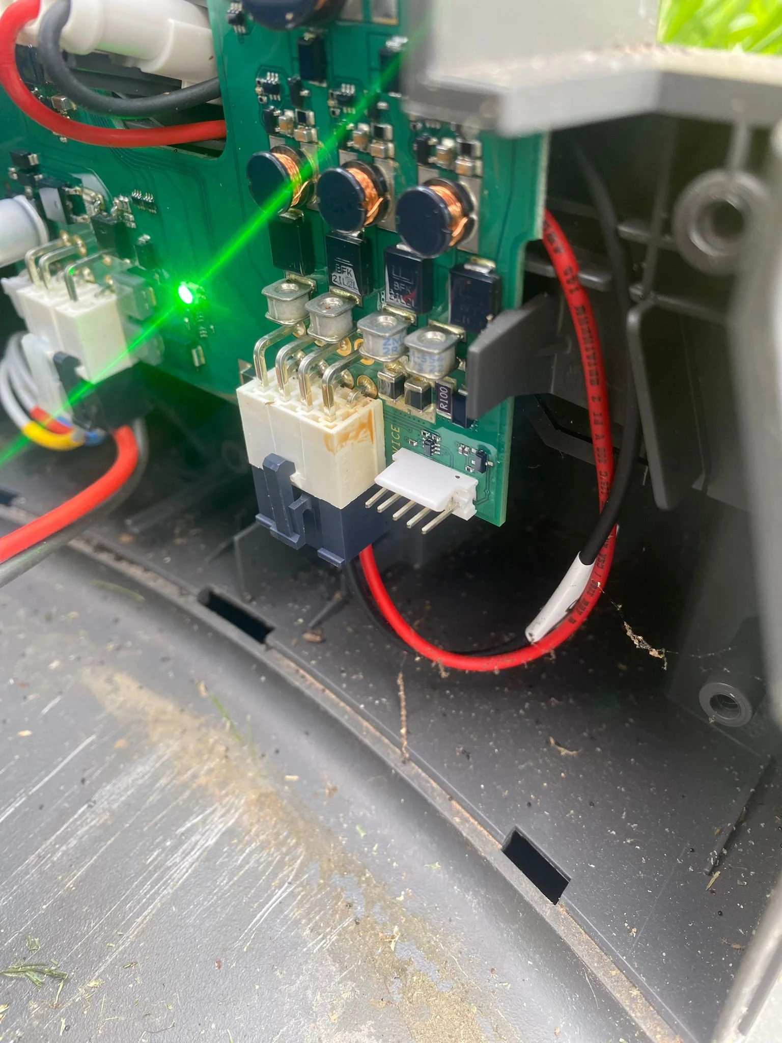 Close-up inspection of a Husqvarna Automower circuit board during fault diagnosis