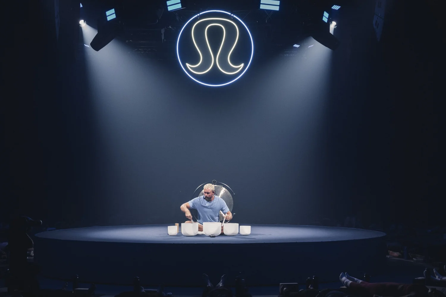 Tom leading the lululemon sound session beneath the illuminated logo