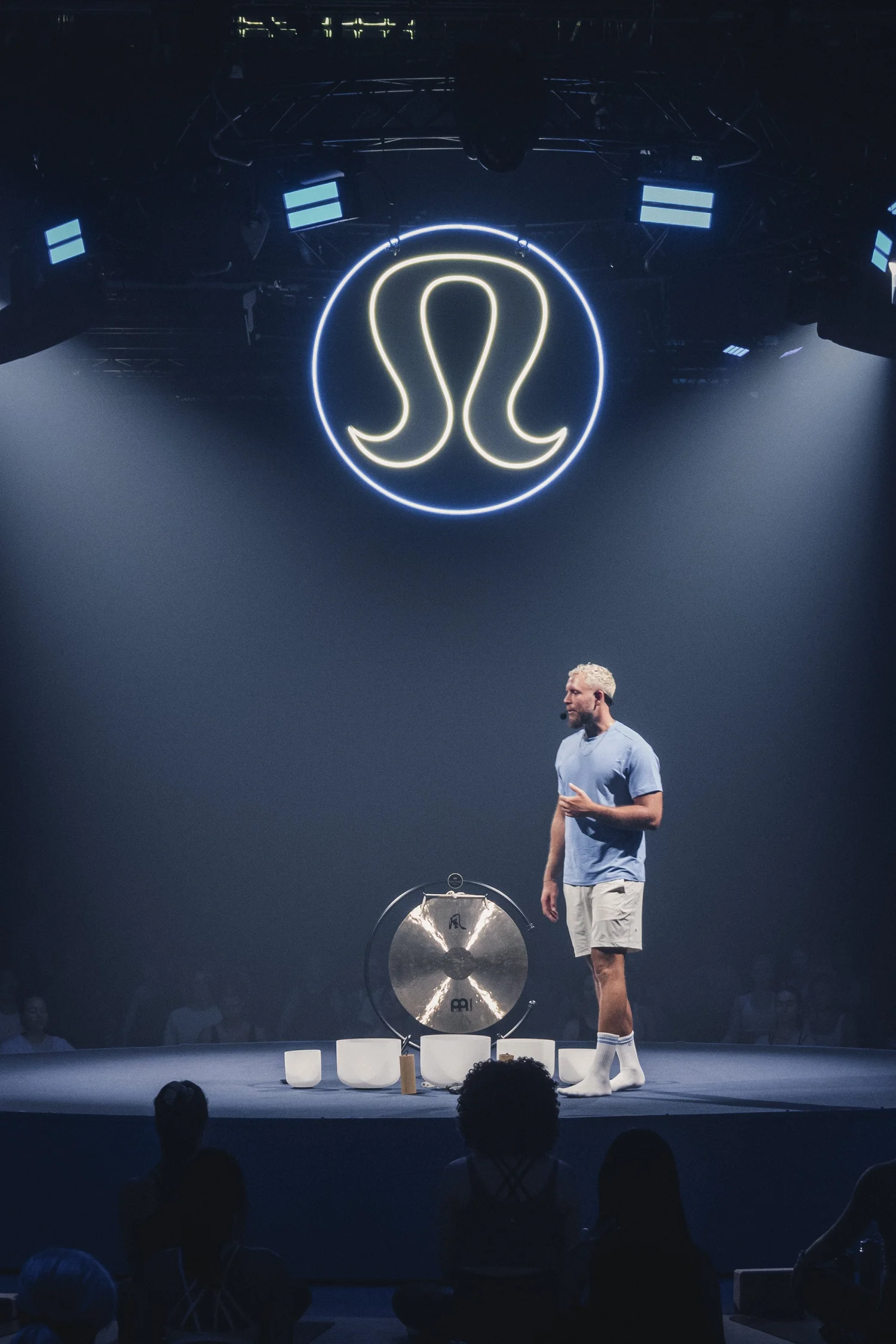 Tom standing beside bowls and gong at lululemon