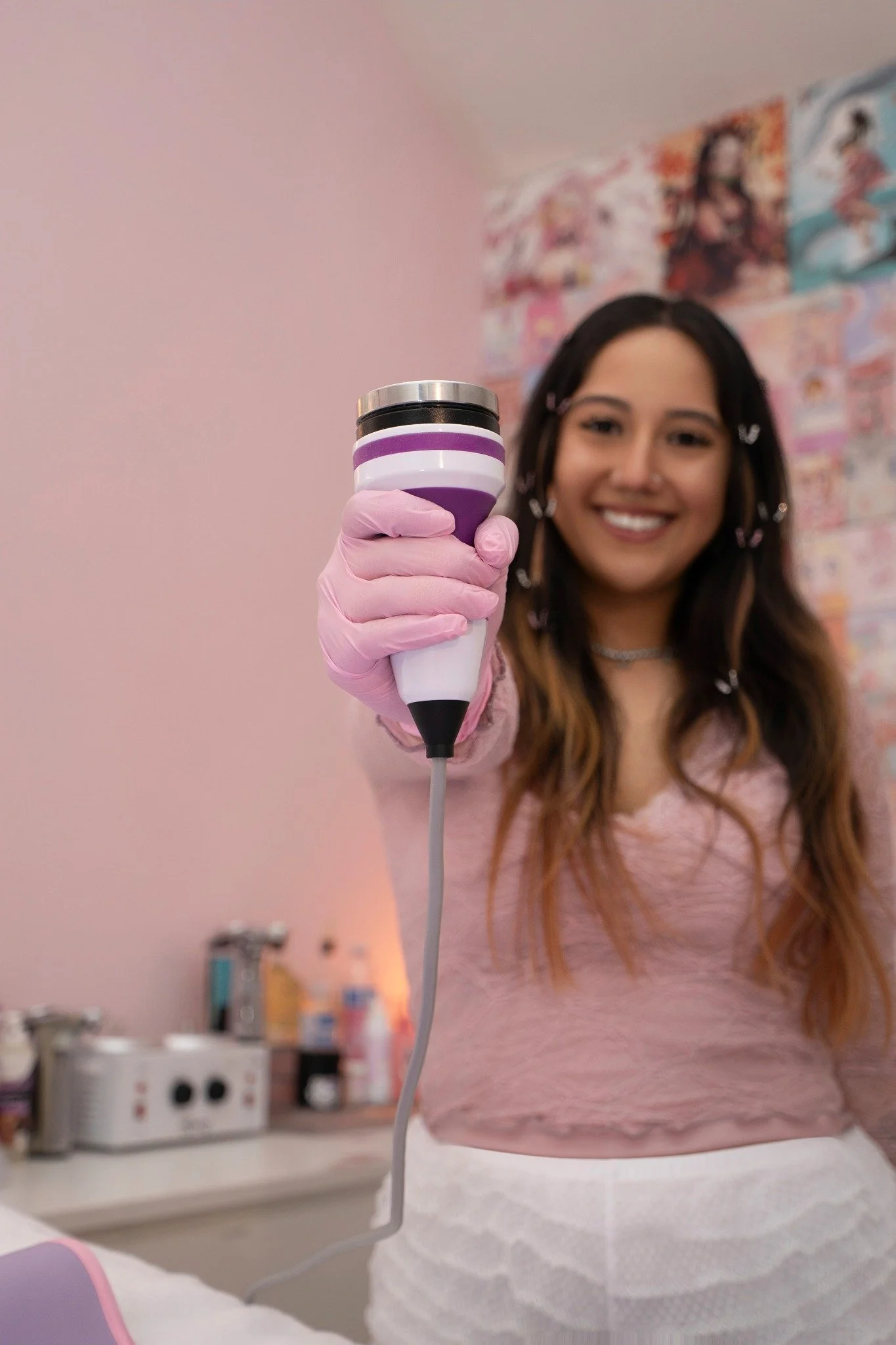 A woman in a pink blouse holding a pink mug during a branding session.
