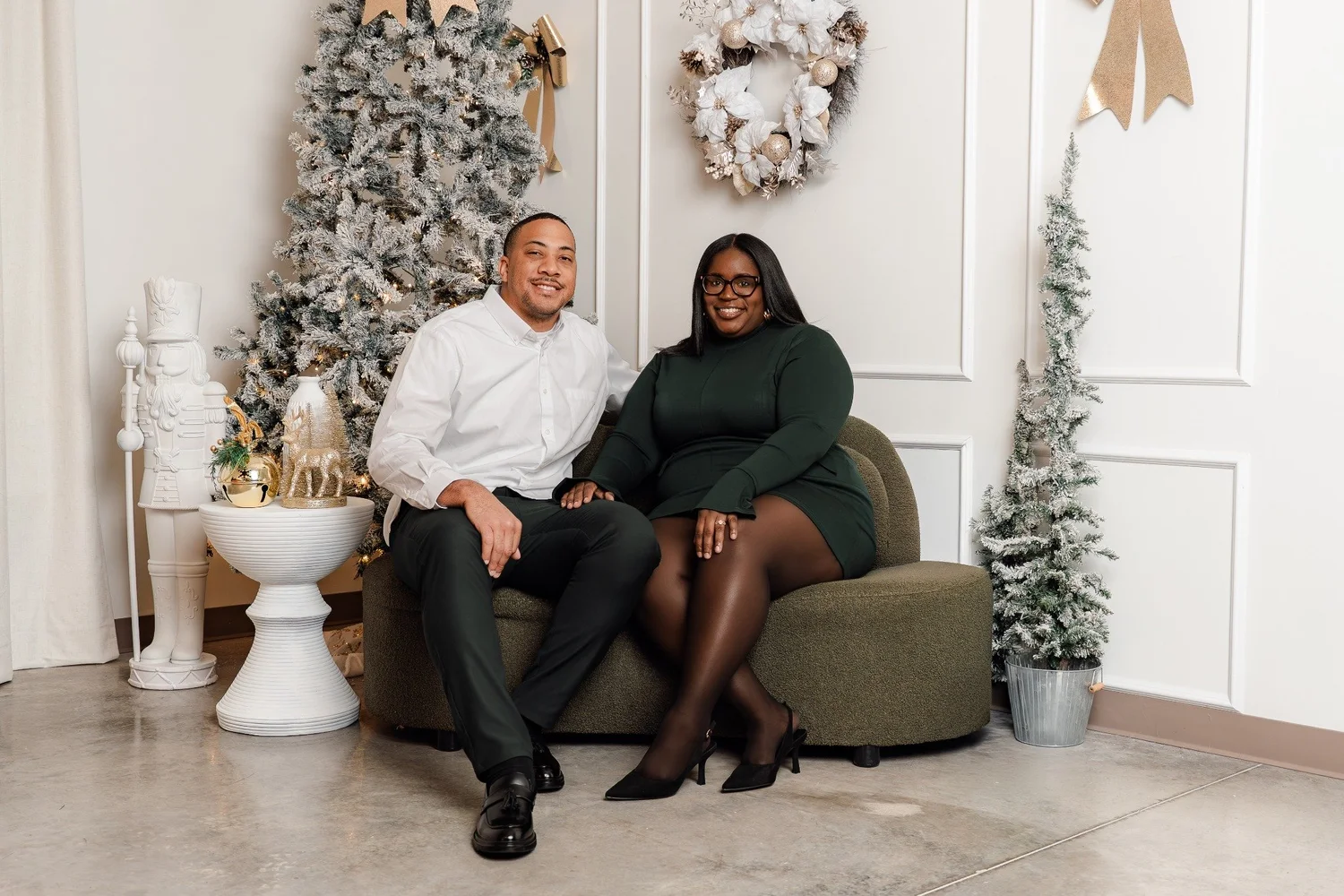Couple seated in a bright white Christmas studio
