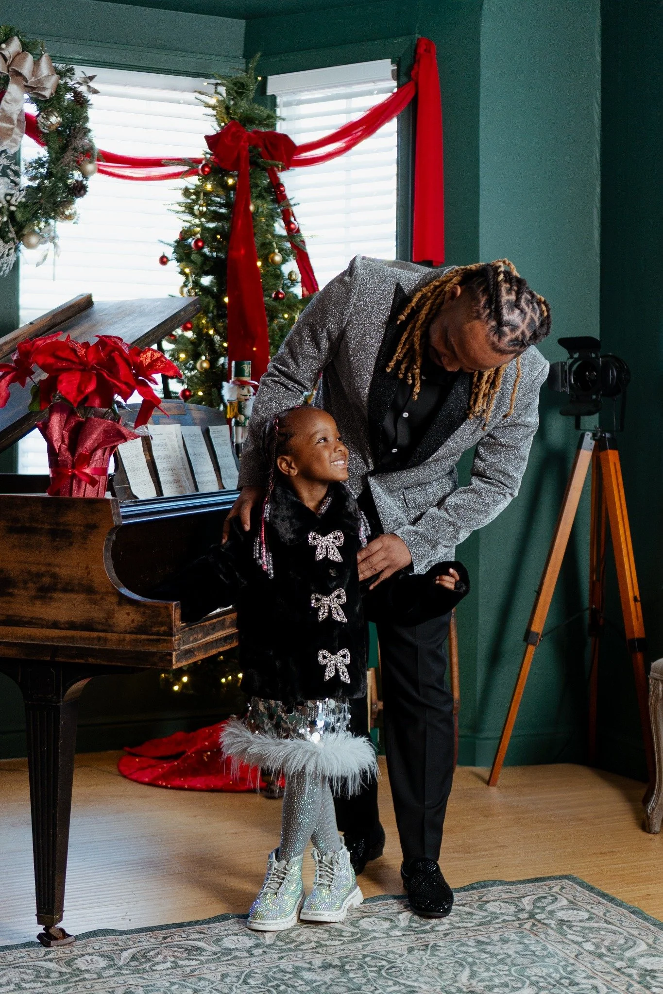 Father and daughter sharing a moment at a Christmas piano
