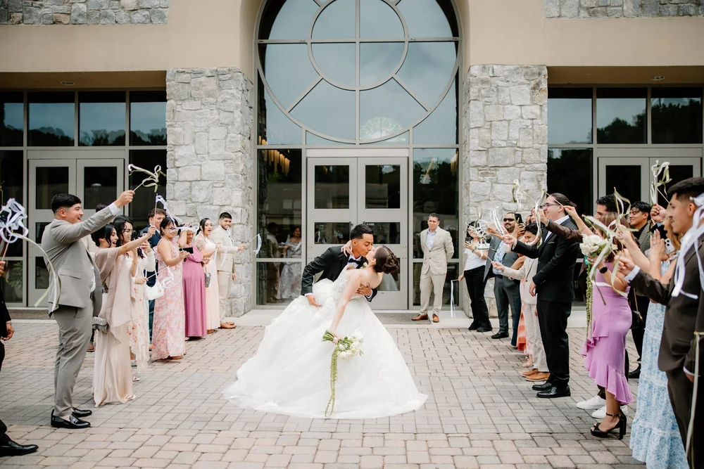 Guests cheering the couple out of the church