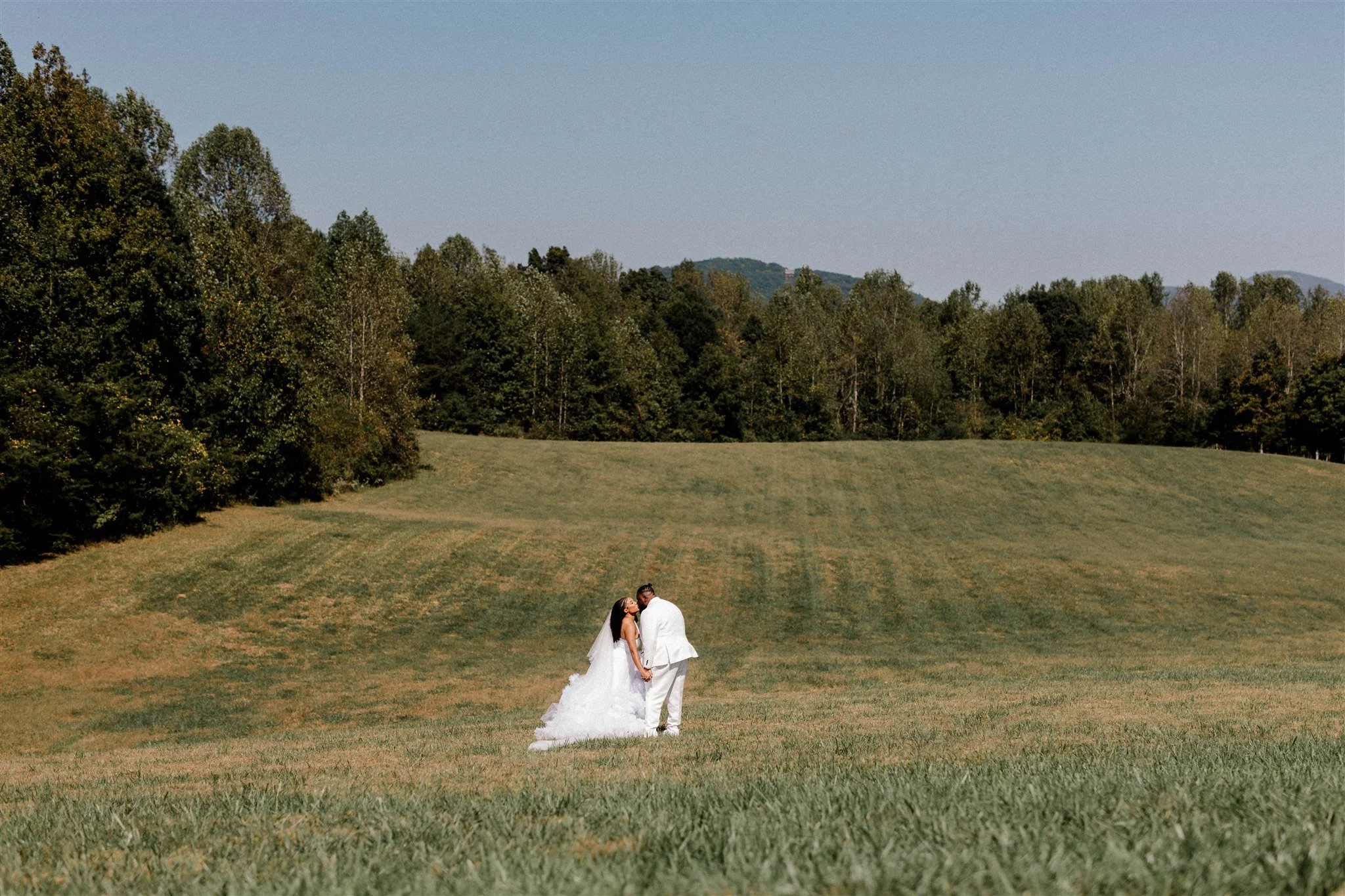 A couple small in a wide open field