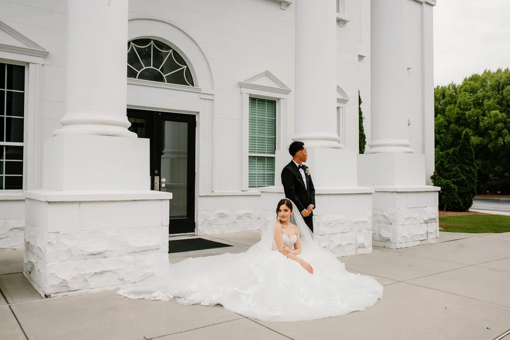 A bride alone against the white chapel