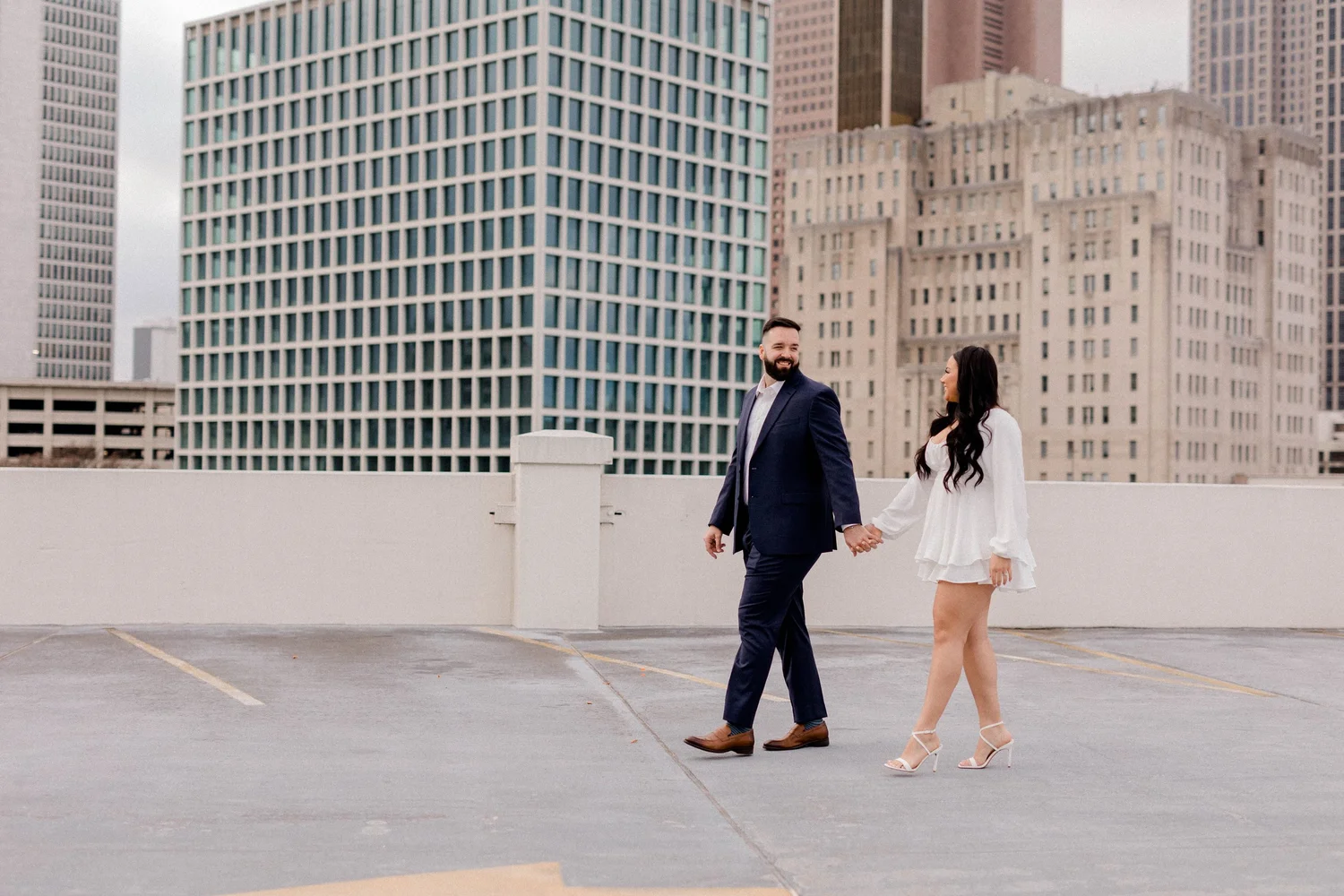 A couple crossing the street downtown