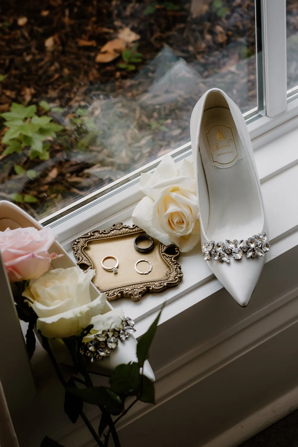 Wedding shoes and the ring box in window light