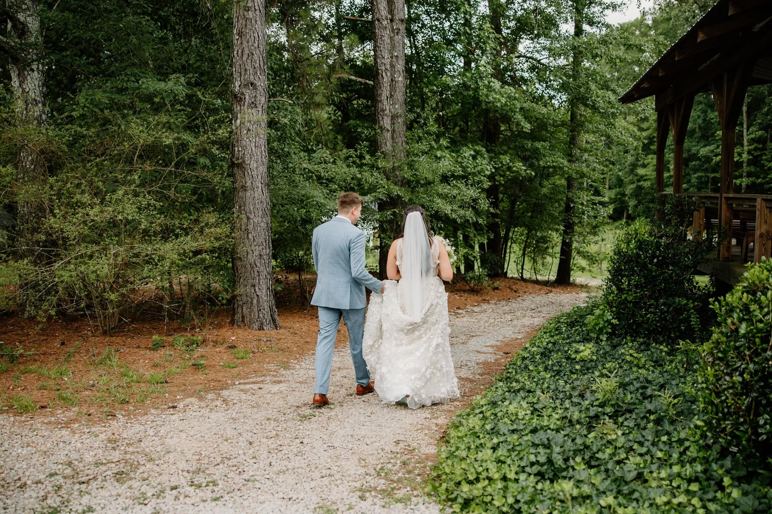 Couple walking a wooded path at Koury Farms
