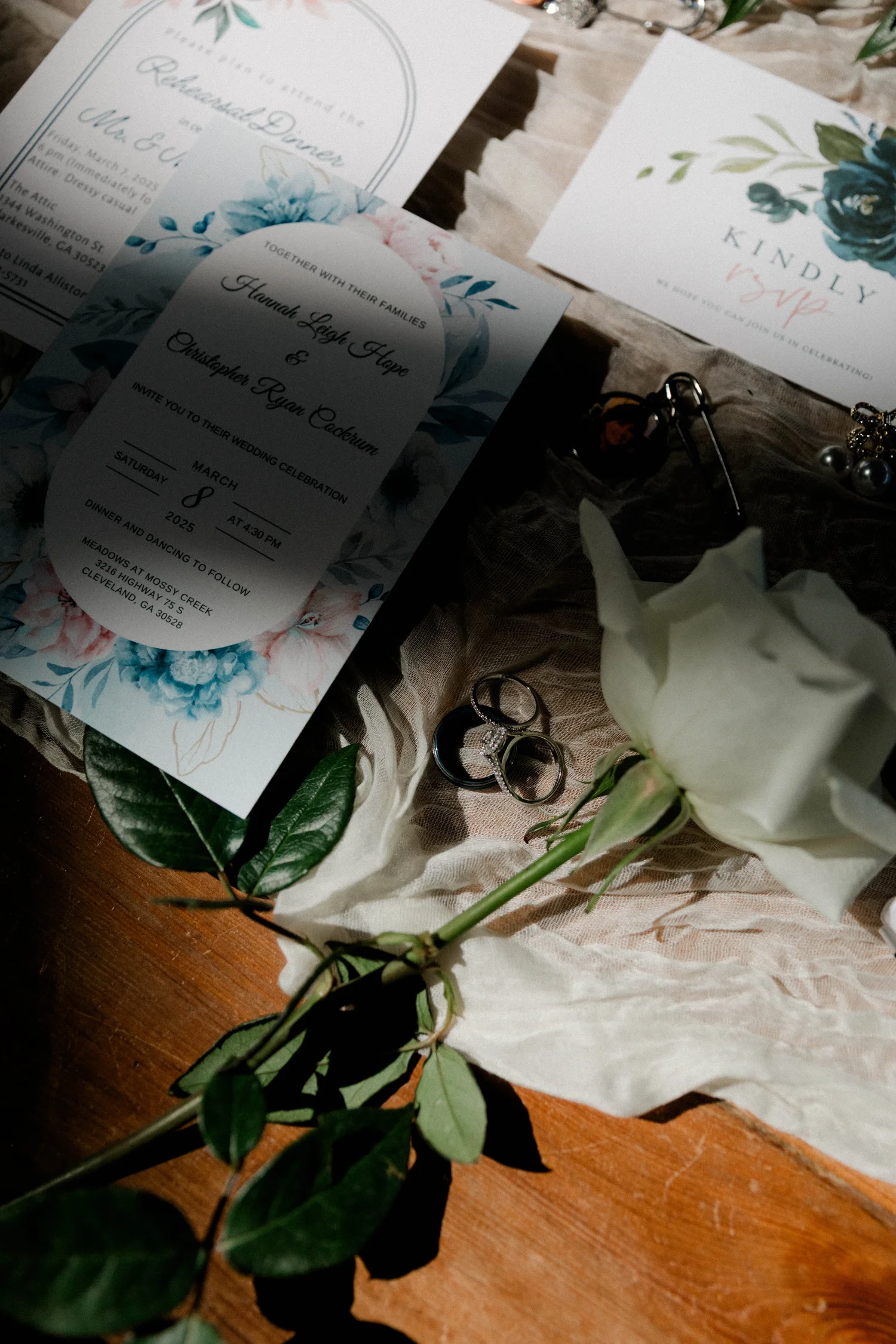 The invitation suite and the rings on green