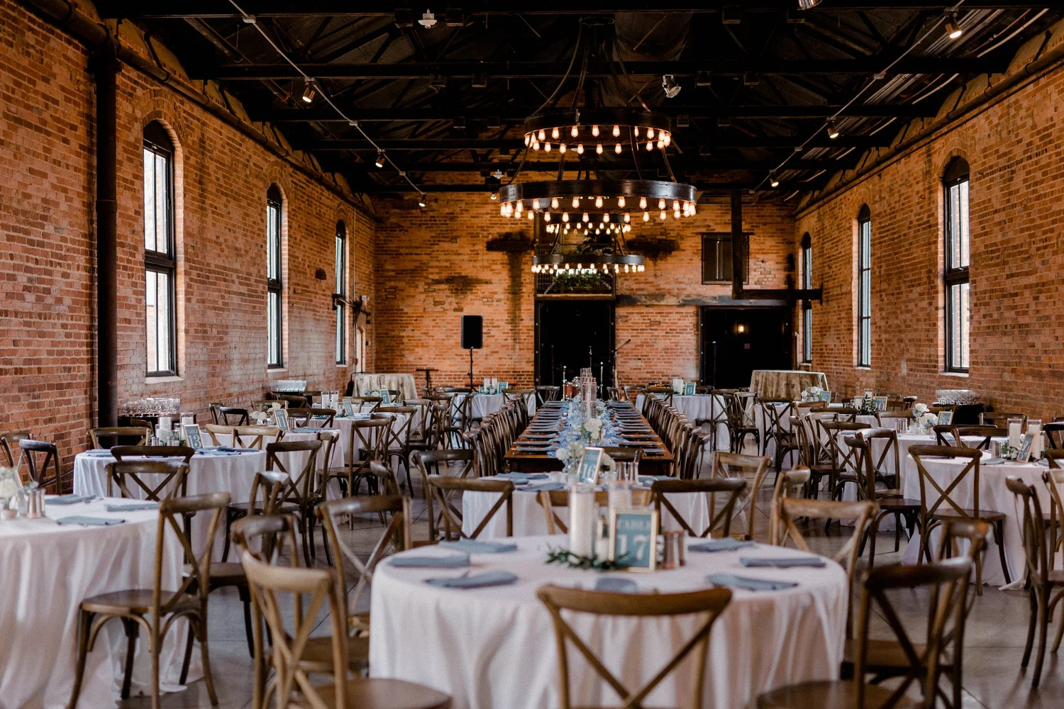 The brick reception hall set for dinner