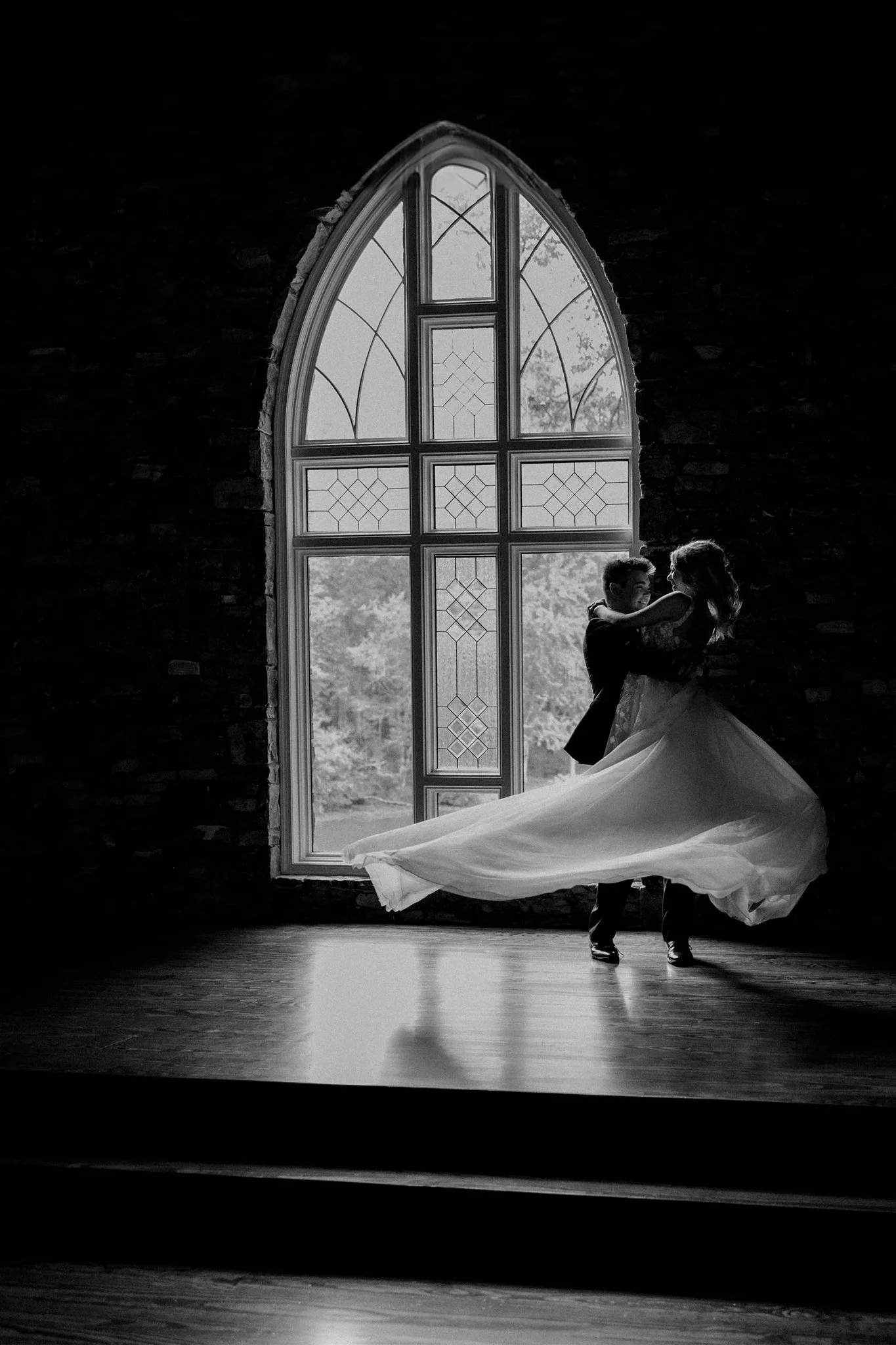 A bride turning in the window light