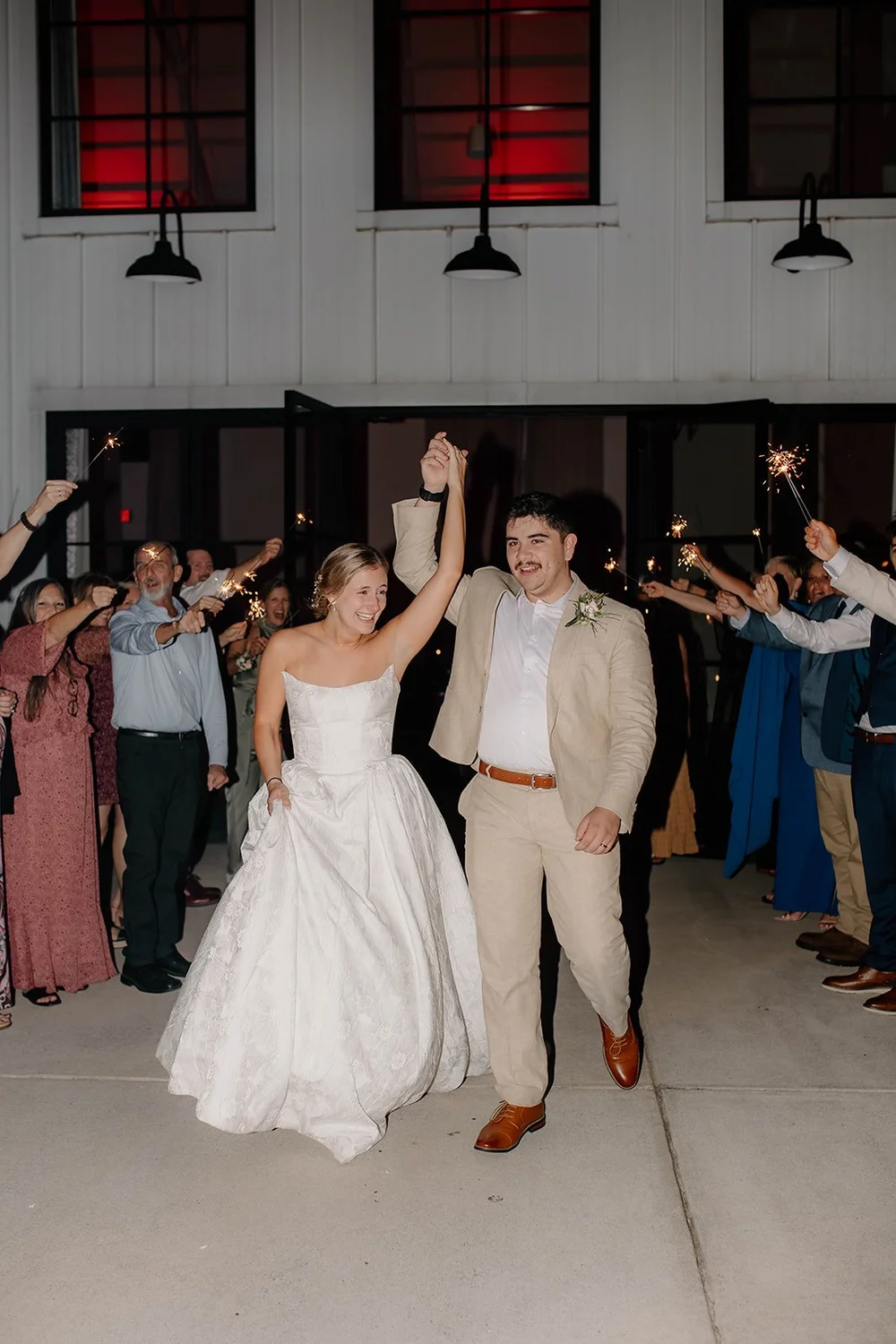 Guests cheering the couple out at the end of the night