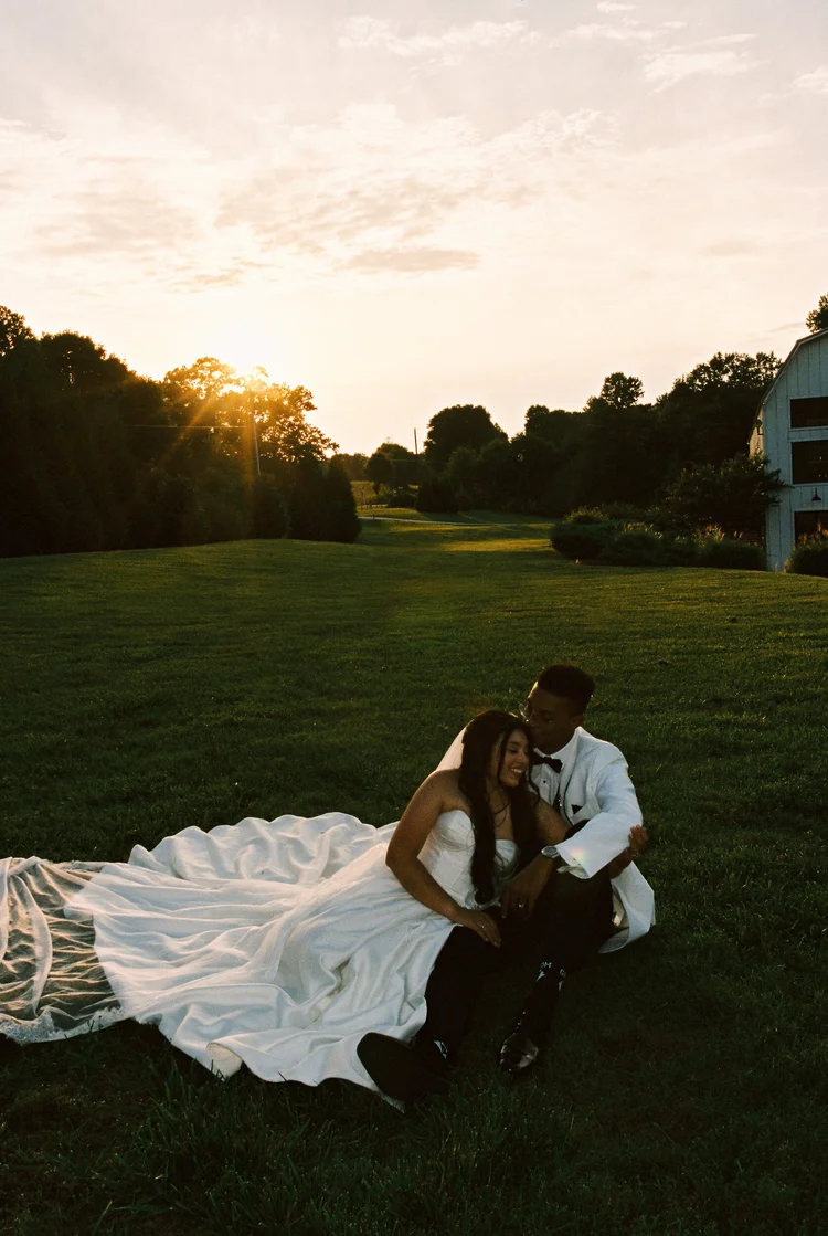 A couple together on the lawn at golden hour, shot on 35mm film