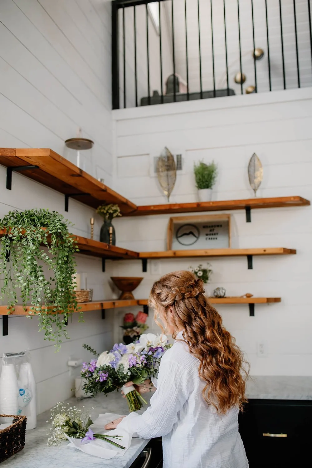 Greenery on the shelves above the bar
