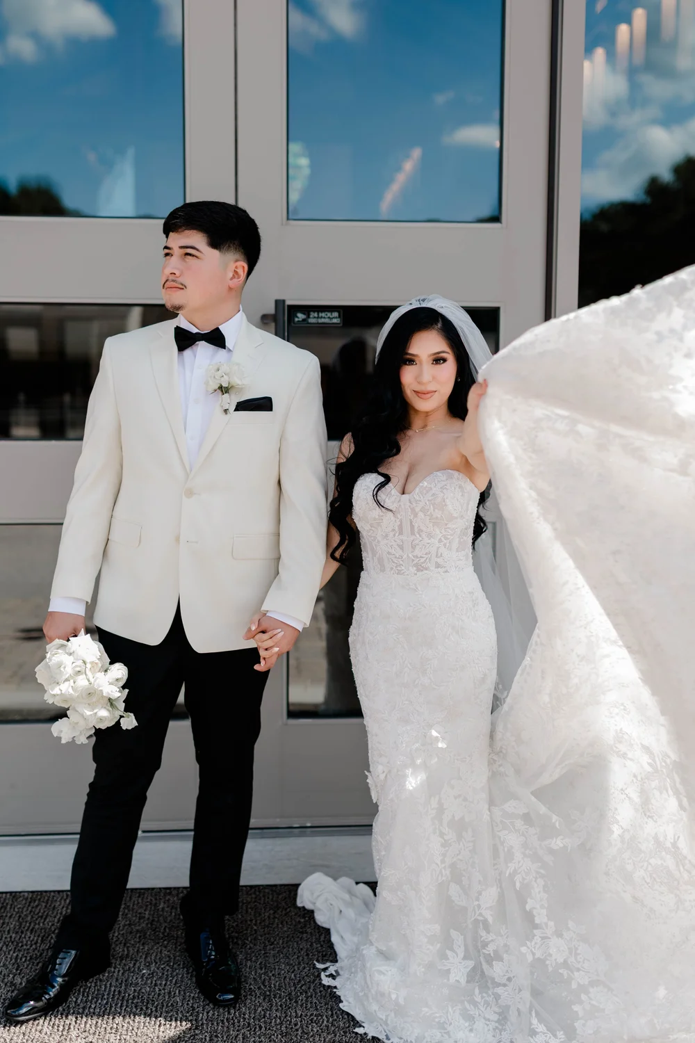 A groom in a white dinner jacket with his bride