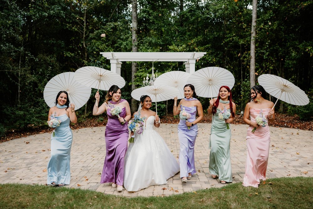 The bridesmaids with their parasols up