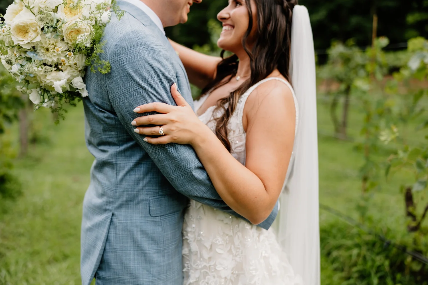 Bride and groom holding each other close at Koury Farms
