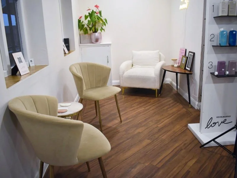 The Escape waiting area with velvet chairs and Kevin Murphy products