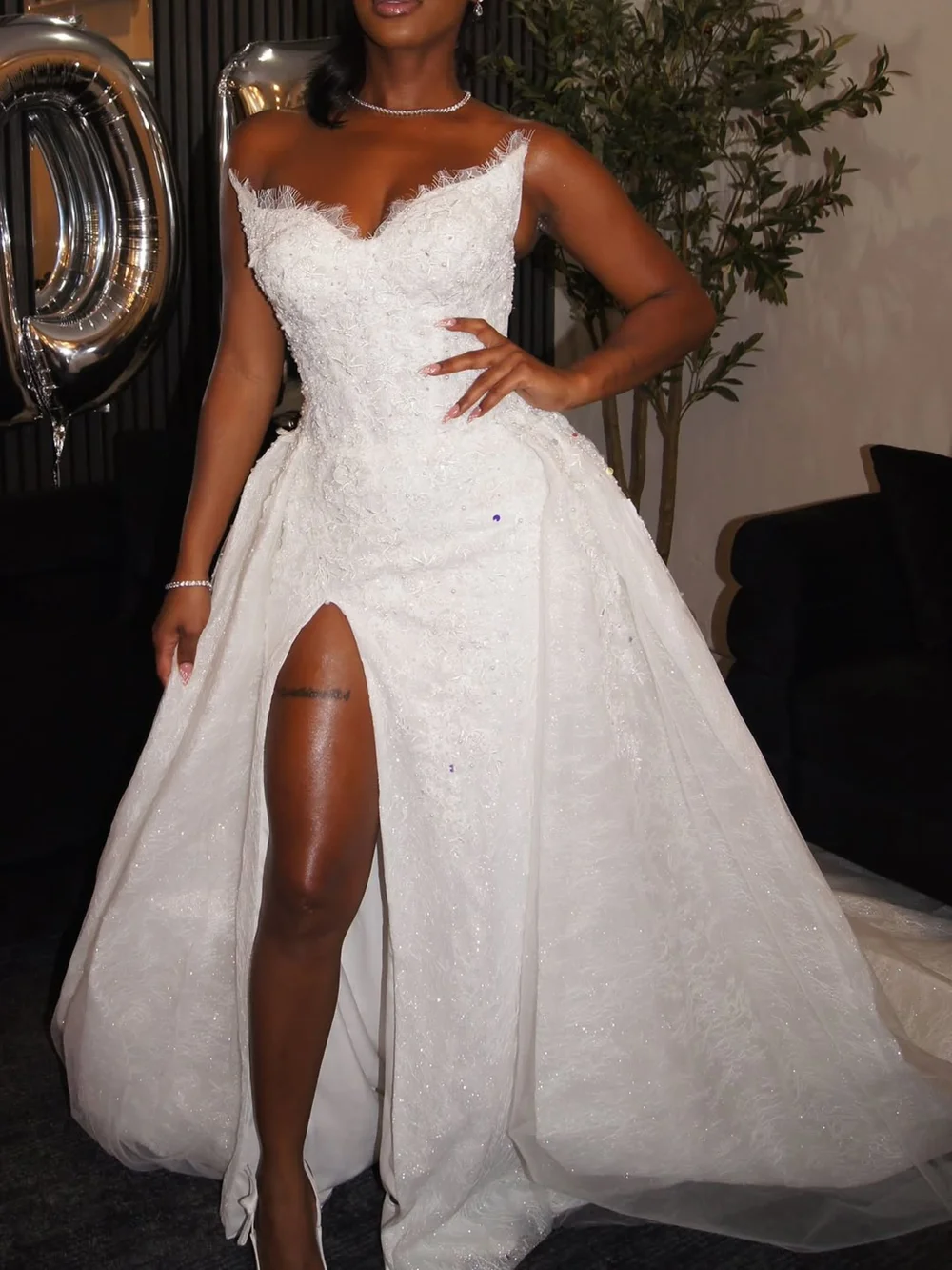 Close-up of the beaded lace bodice, high slit and overskirt on Alize’s custom 2-in-1 wedding gown by Estelle Bridal