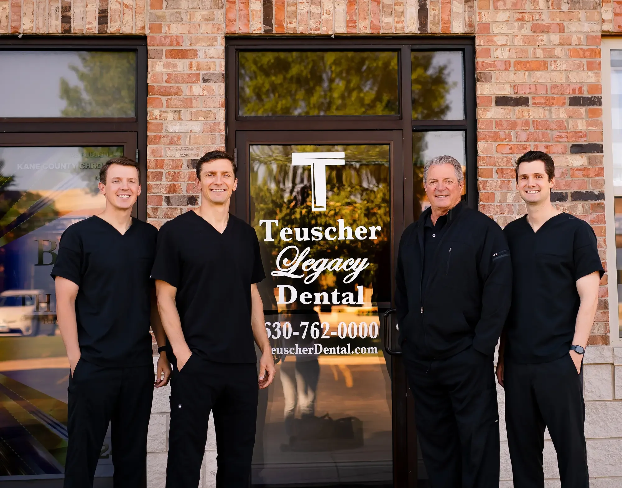 The Teuscher Legacy Dental doctors together outside their St. Charles, Illinois office