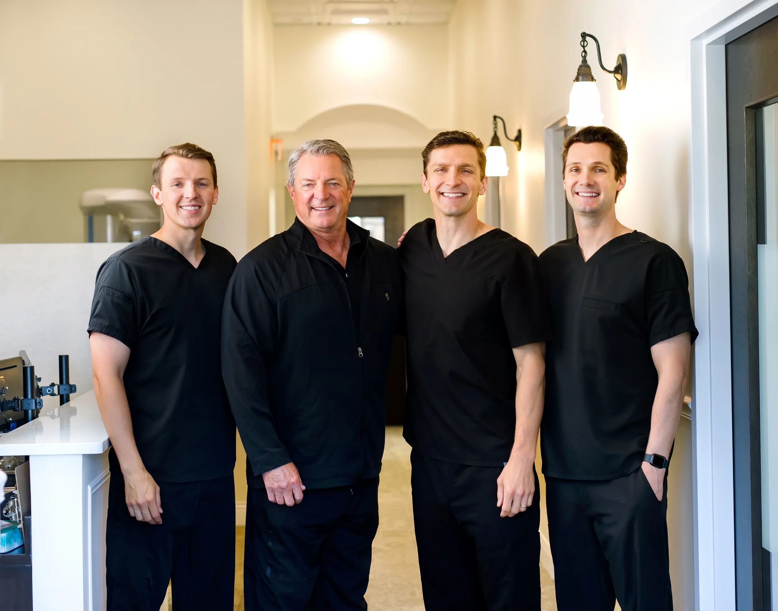 The four Teuscher Legacy Dental doctors inside their modern St. Charles, IL office