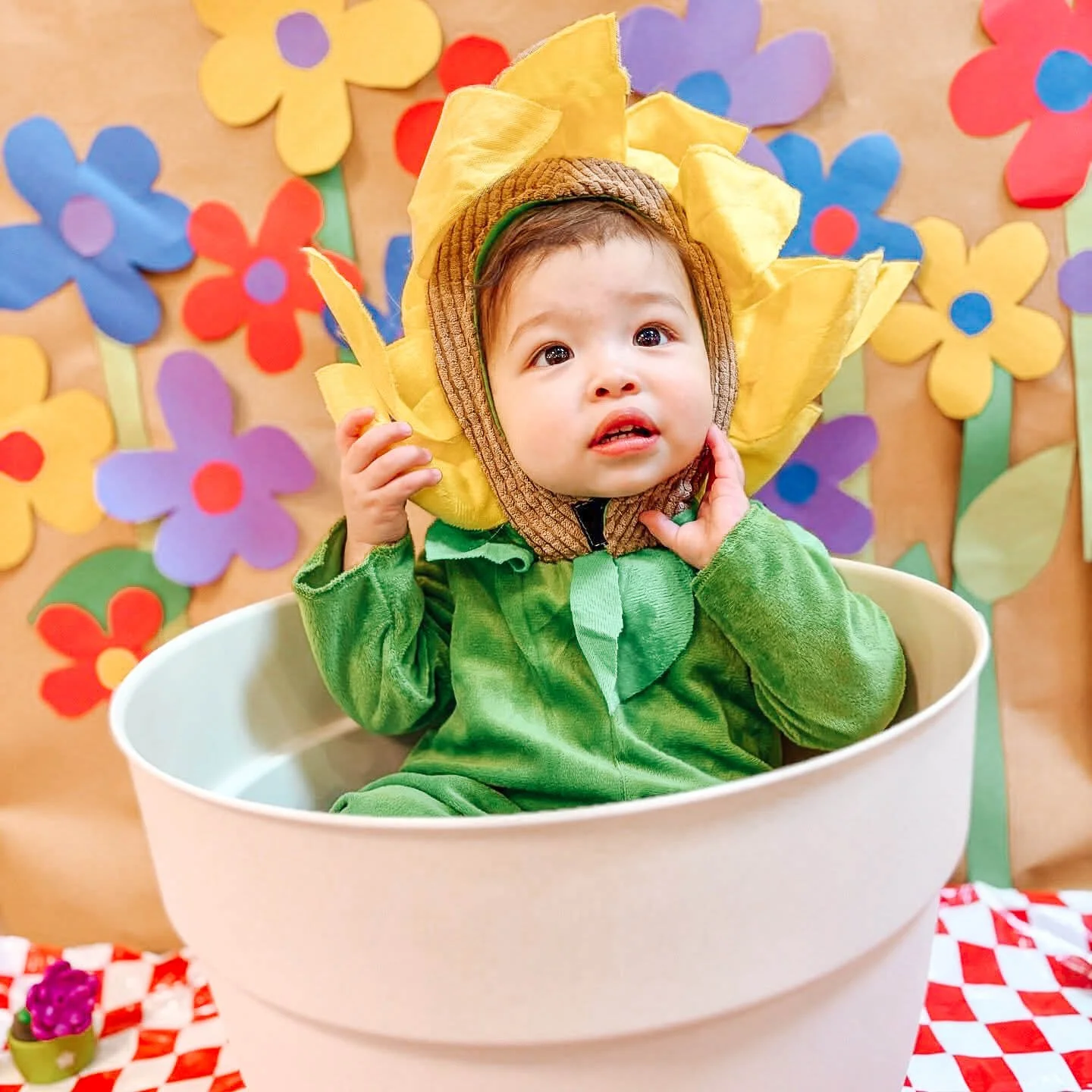 Baby dressed as a chef with yarn spaghetti