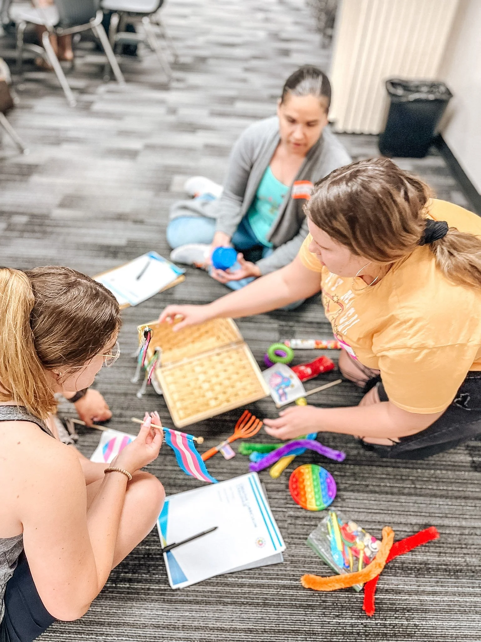 Teachers working together with sensory play materials