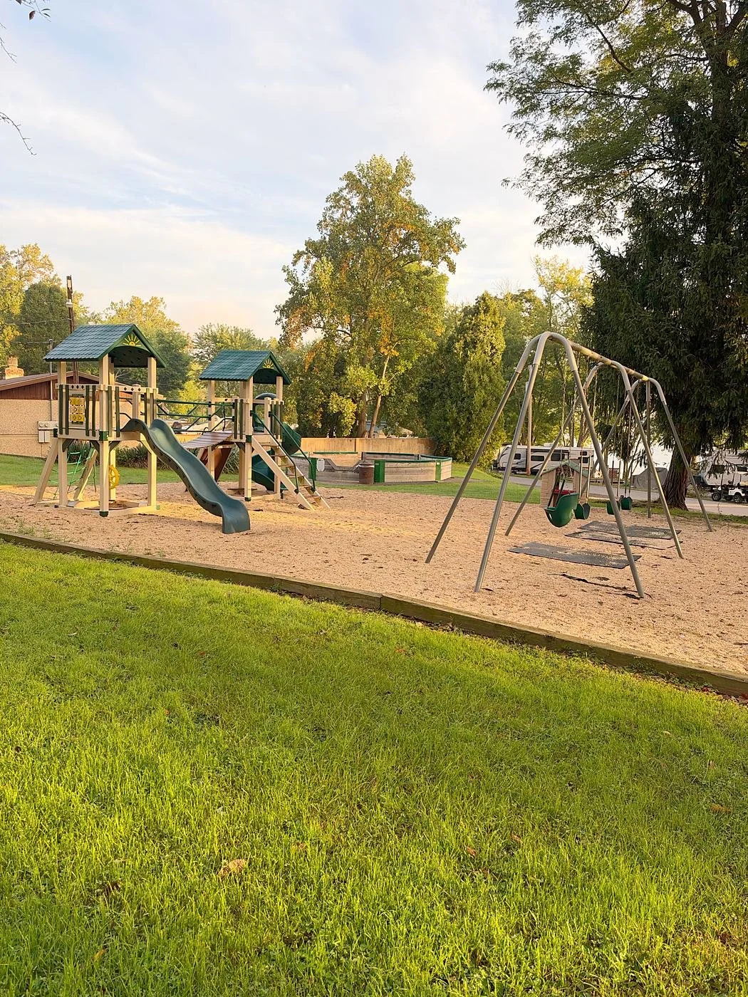The campground playground, with two play towers, slides, and swings
