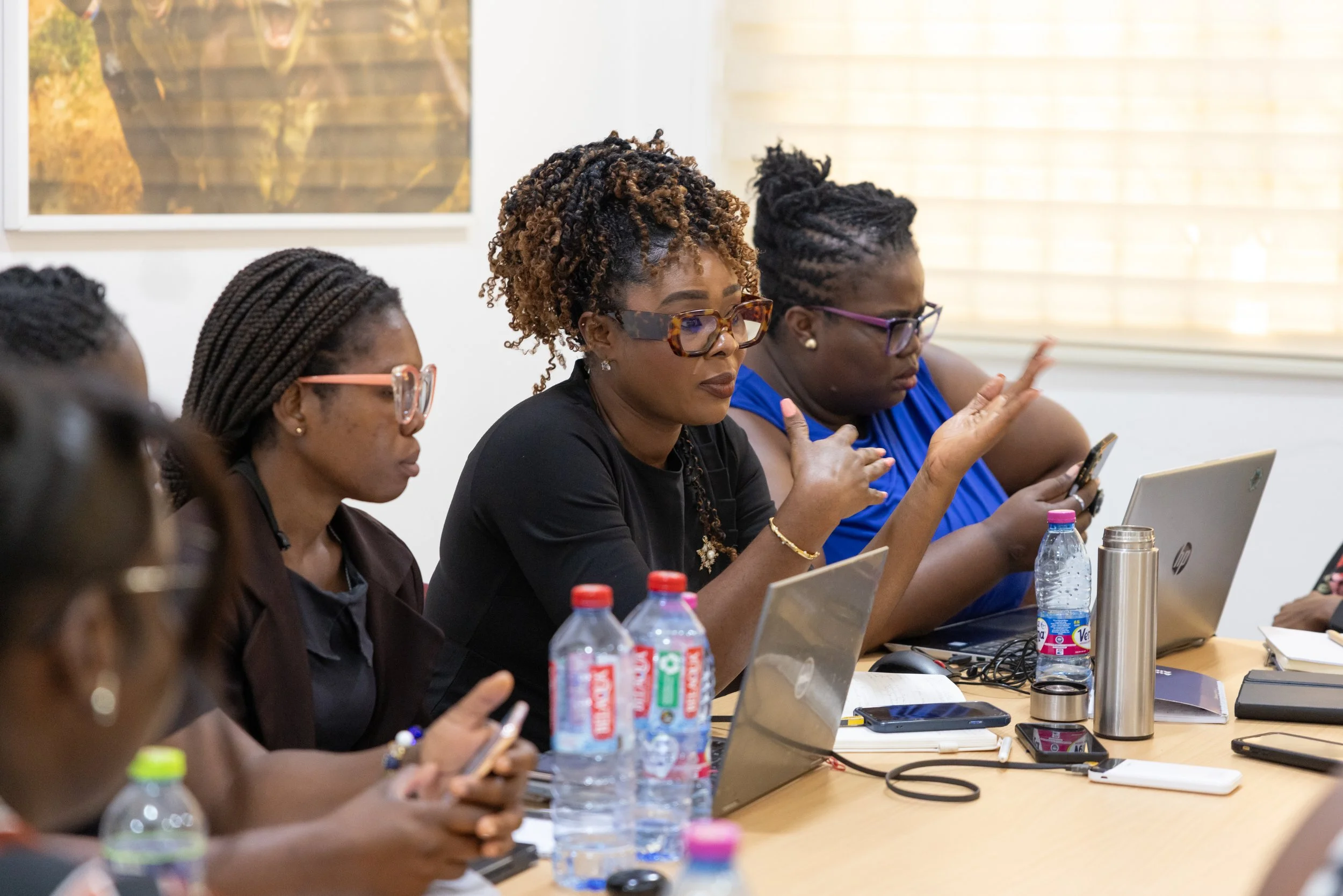 Participants gathered around a table during a HerPress class session.