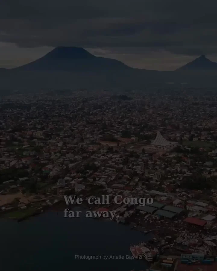 Congo, Close to Home announcement artwork showing a view of Goma, with mountains beyond.