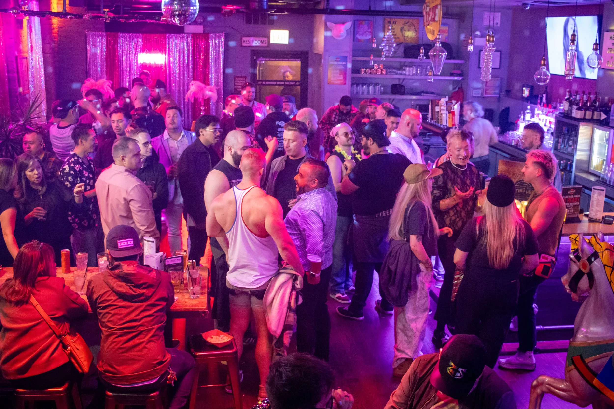 Friends socializing at Meeting House Tavern gay bar Chicago Andersonville
