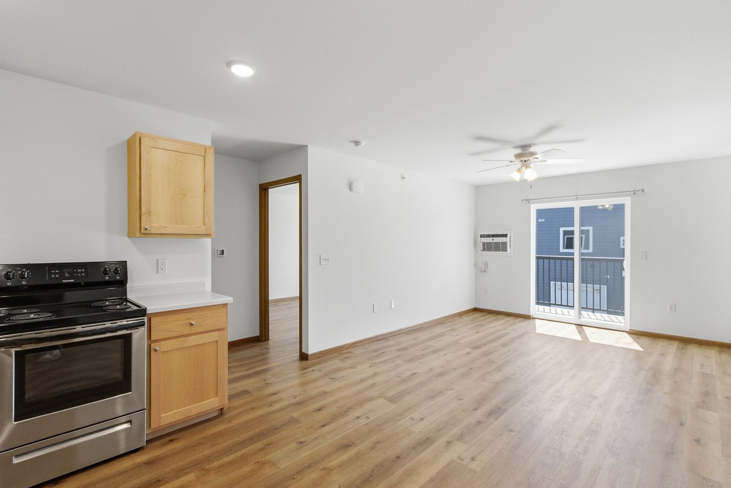 Greenfield Estates 2 bedroom over garage — living room with balcony access