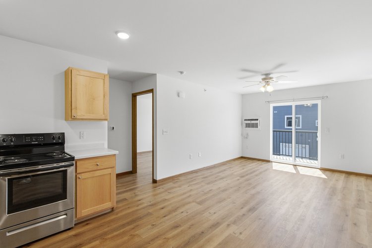 Greenfield Estates 2 bedroom over garage — living room with balcony access