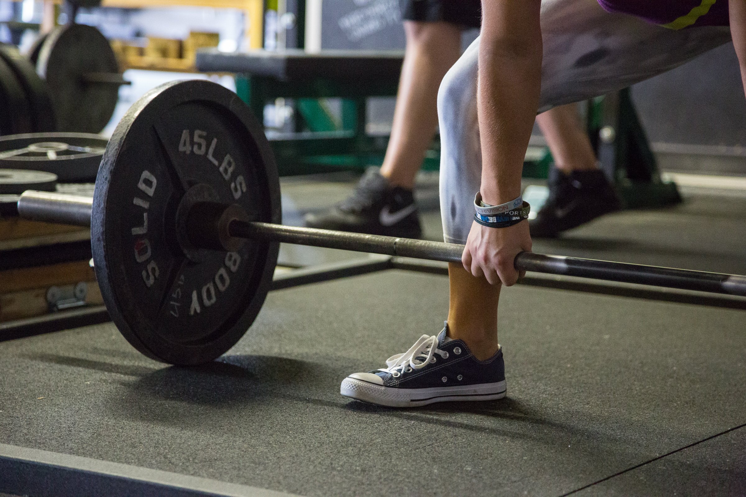 Close-up of a hand gripping a barbell at The Spot Athletics