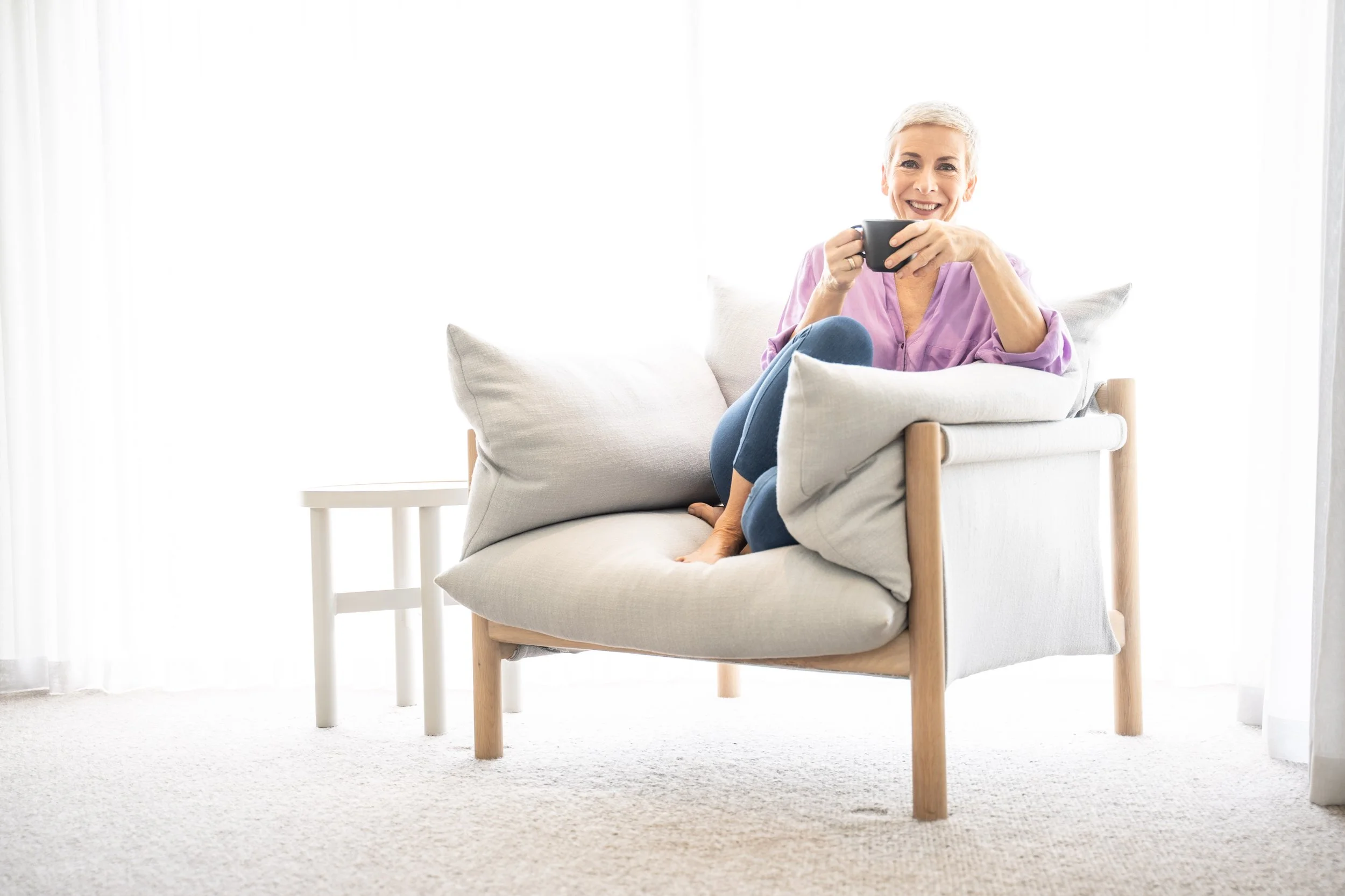 Natalie Woodman smiling with a cup of tea