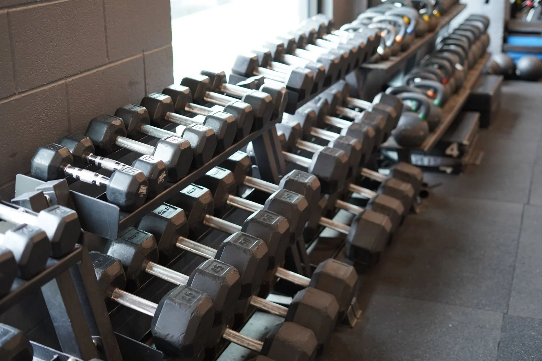 Racks of dumbbells and kettlebells